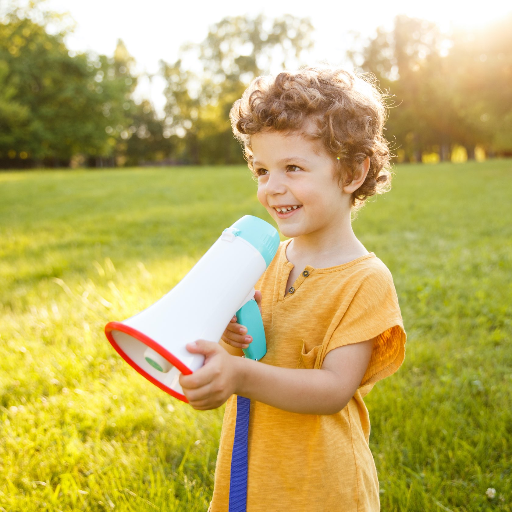 Young child with megaphone, standing outside