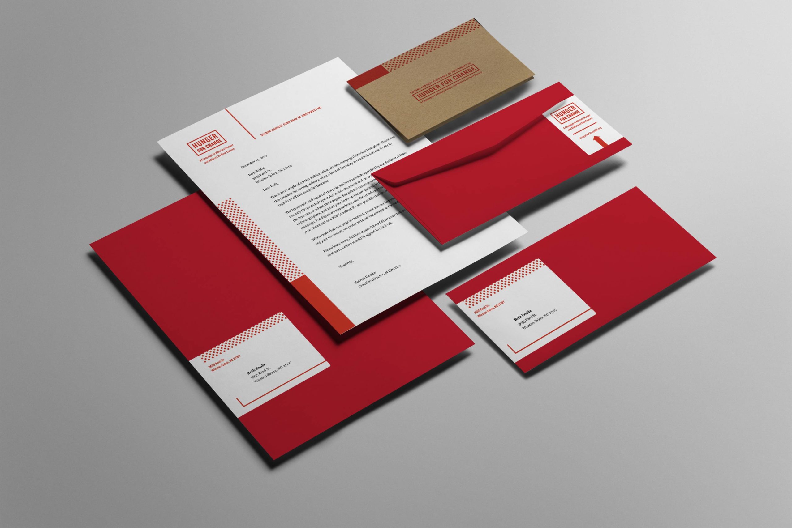 Overhead image of pocket folder, letterhead, envelopes, and notecard for campaign